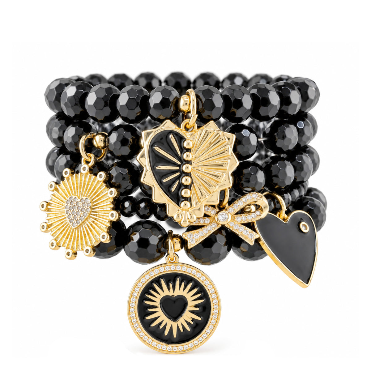 Love Lisa Remi black onyx bracelet stack with faceted black gemstone beads, gold-tone sunburst heart charms, black enamel hearts, pavé bow, and sparkling crystal details on white