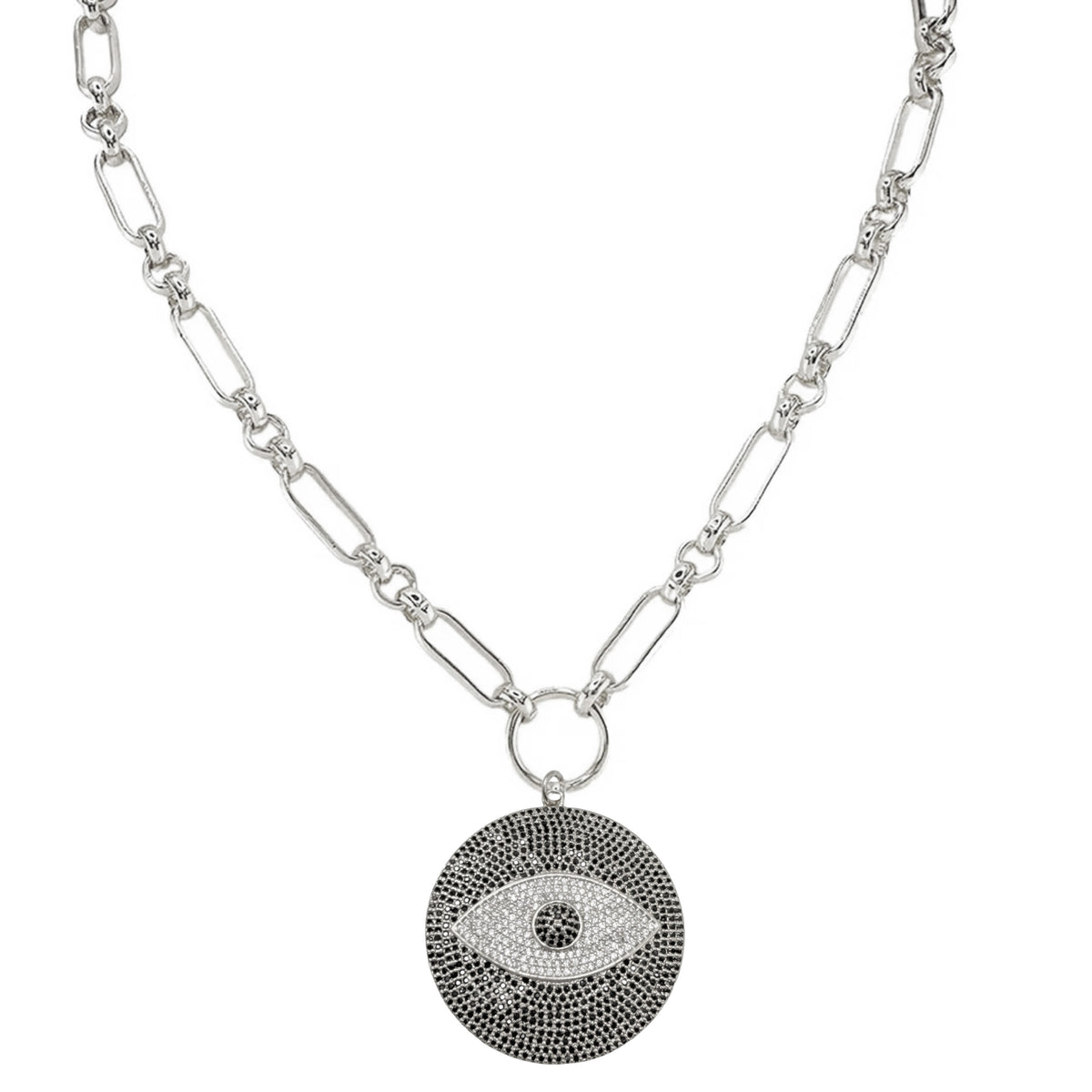 A silver-toned chain necklace featuring a circular evil eye pendant. The pendant is detailed with a textured black outer border, a white center, and a small black pupil, suspended from a polished silver ring on a white background.