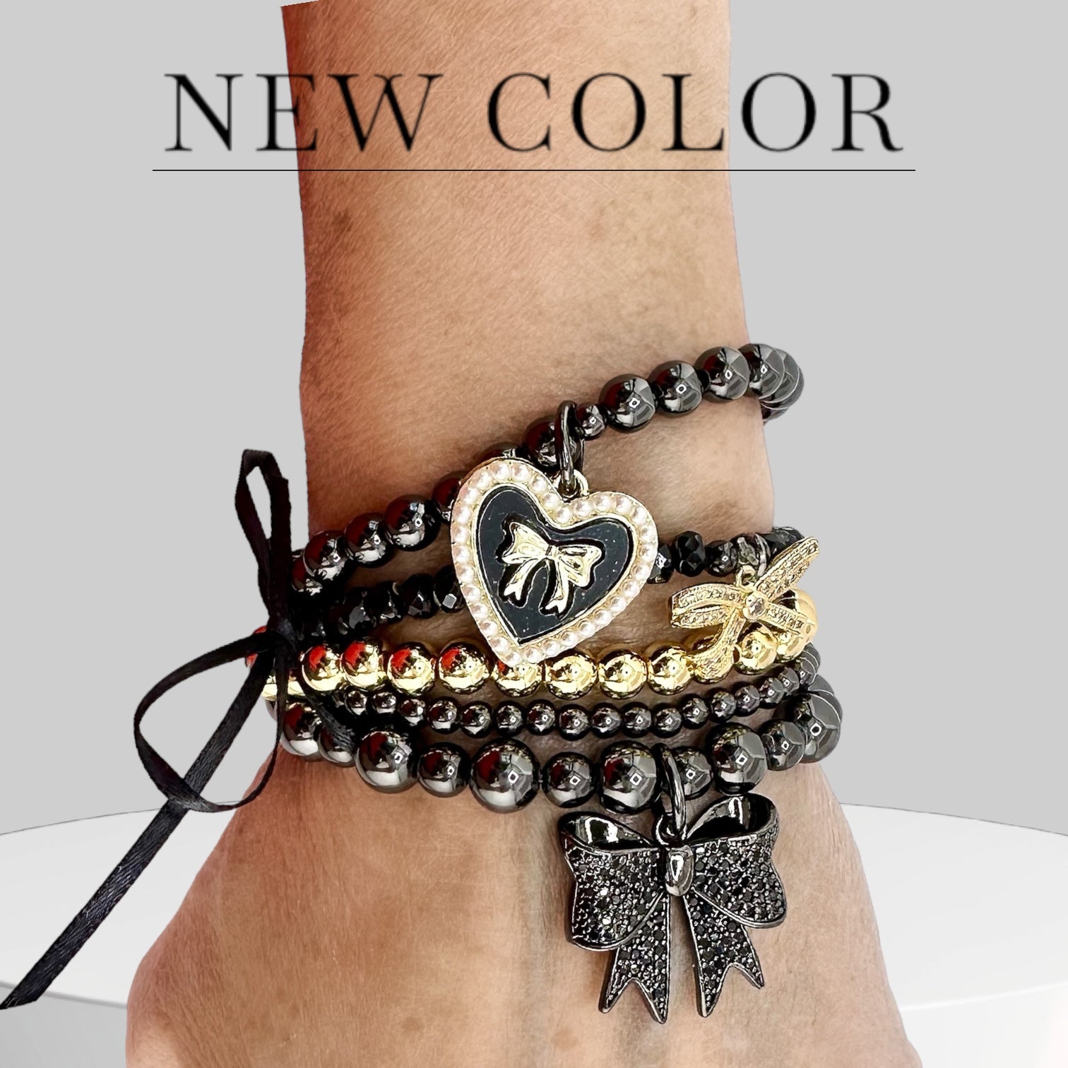 love lisa bow bracelet gunmetal on wrist