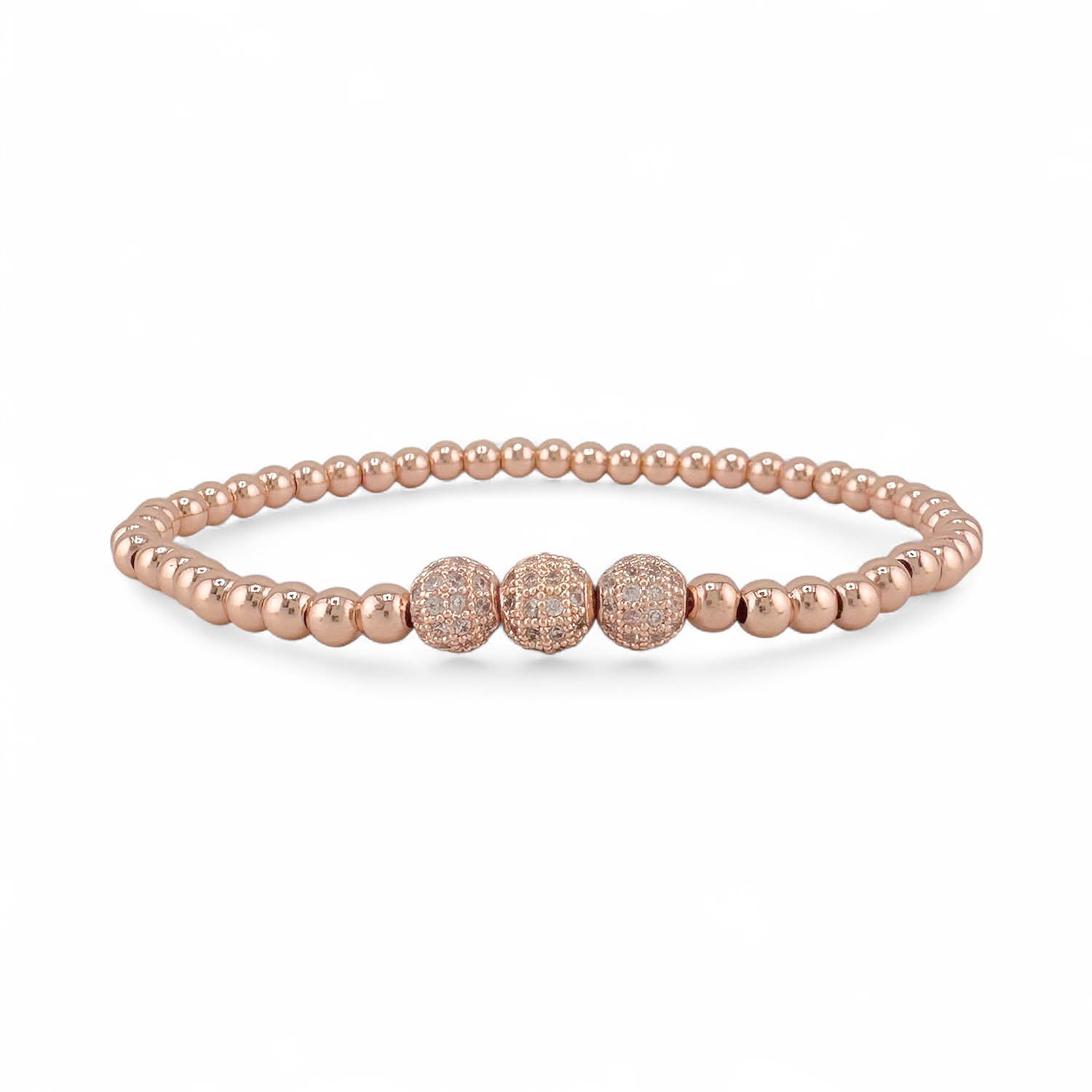 Rose gold beaded bracelet with three glittery beads on a white background