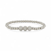 Silver beaded bracelet with three diamond-studded beads on a white background