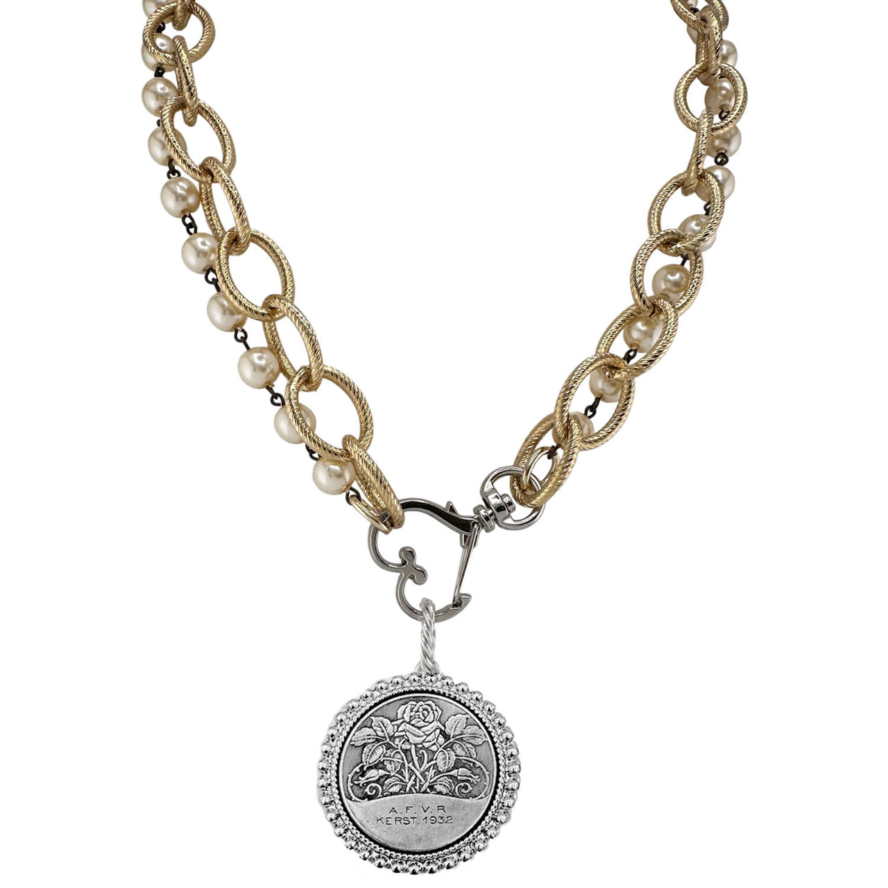 Necklace with gold chain, pearl beads, and silver medallion on a white background