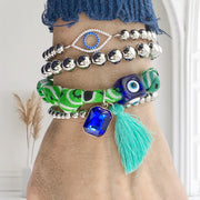 Arm stacked with Love, Lisa Roxie Bandana Charm Bracelets in assorted colors and charms