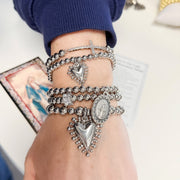 Love Lisa sacred heart blessed mother bracelet stack silver worn layered on wrist five stretch bracelets with cross medallion and heart charms 6 85 inches