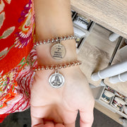 Love Lisa Saint Agatha Breast Cancer Survivor Bracelet worn on wrist with polished beads and Saint Agatha medal