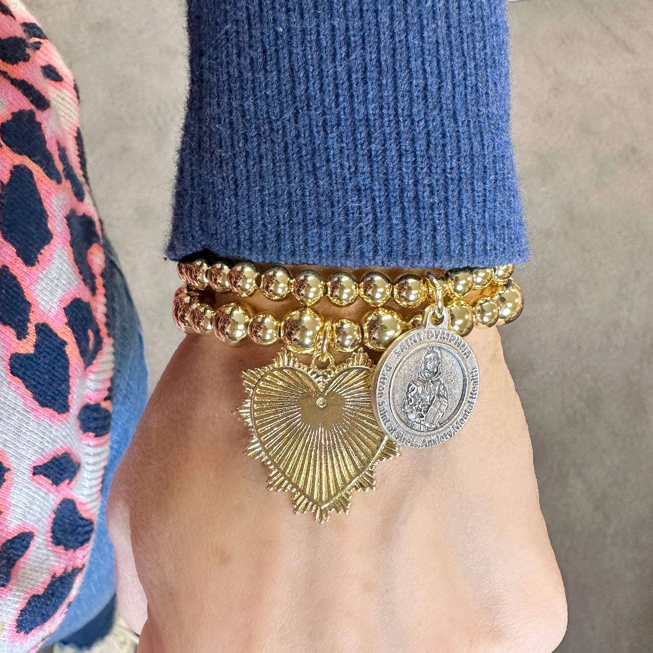 aint dymphna bracelet gold worn on model showing charm detail love lisa