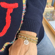 Love Lisa saint gerard fertility bracelet worn on wrist beaded stretch bracelet with medal for pregnancy support and motherhood