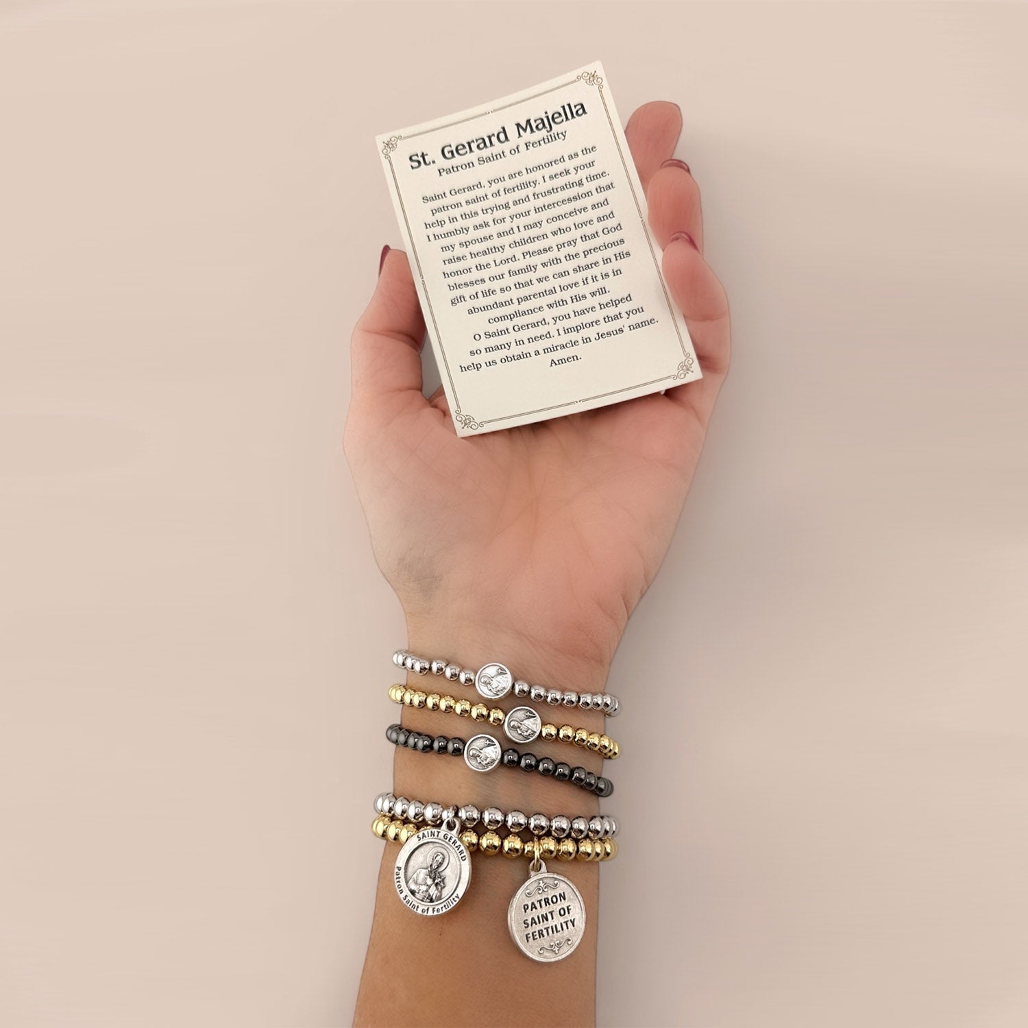 Stack of st. gerard bracelets with the prayer card