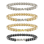 Set of four beaded bracelets with 'BRAVE' text on a white background