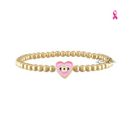 Love Lisa Sandi Breast Cancer Awareness Bracelet with polished gold-tone beads and a pink enamel heart-shaped evil eye centerpiece on white
