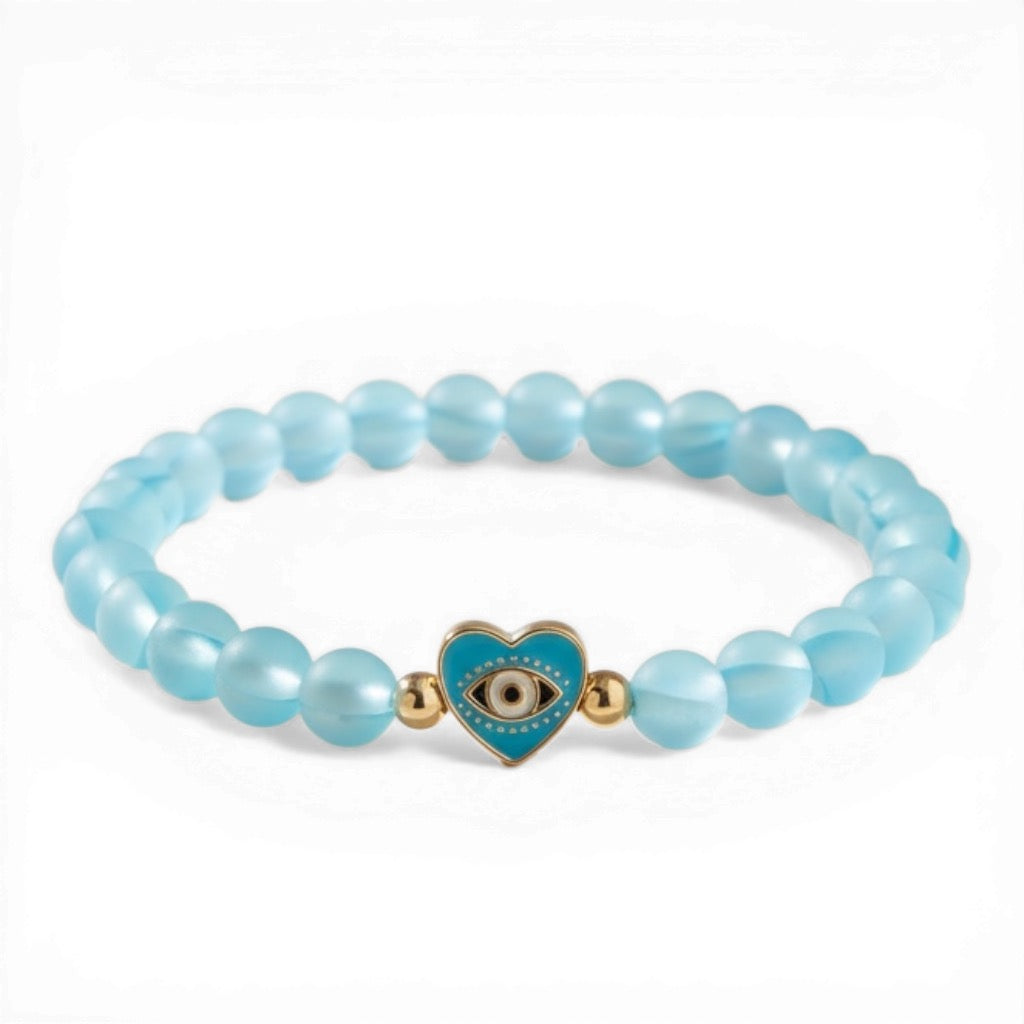 Sandi Heart of Protection blue mermaid evil eye bracelet with glowing blue beads and gold heart charm with evil eye center