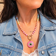Love Lisa Santorini Evil Eye Crystal Paperclip Necklace worn layered with colorful crystal beads gold paperclip chain and pink evil eye charm