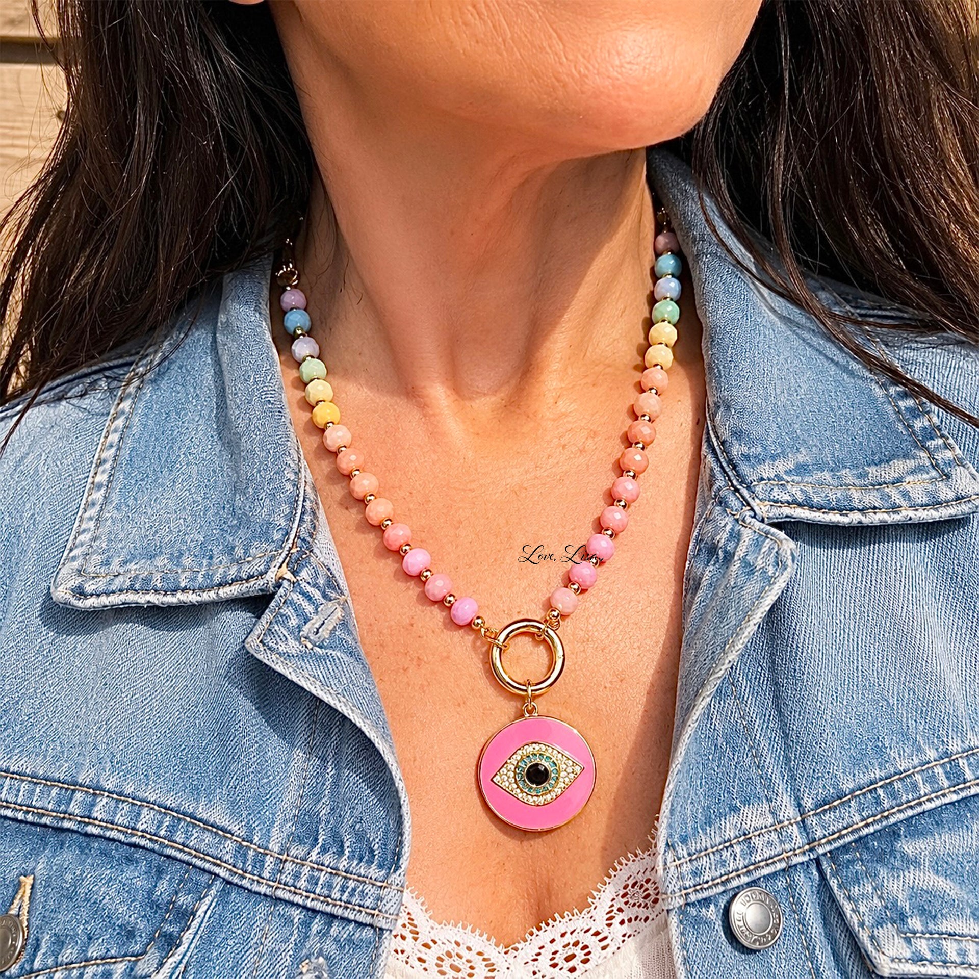Love Lisa Santorini Evil Eye Crystal Paperclip Necklace worn layered with colorful crystal beads gold paperclip chain and pink evil eye charm