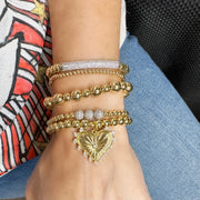 love lisa gold heart charm beaded bracelet stack styled on wrist layered jewelry look for women