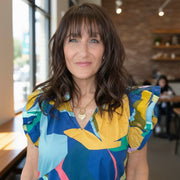 woman wearing the sarah jessica parker heart necklace in gold