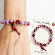 Love Lisa Scarlett Cardinal Gemstone Bracelet worn with red fire agate  gemstone beads, red cardinal charm, and gold-tone accents shown with always with you card 