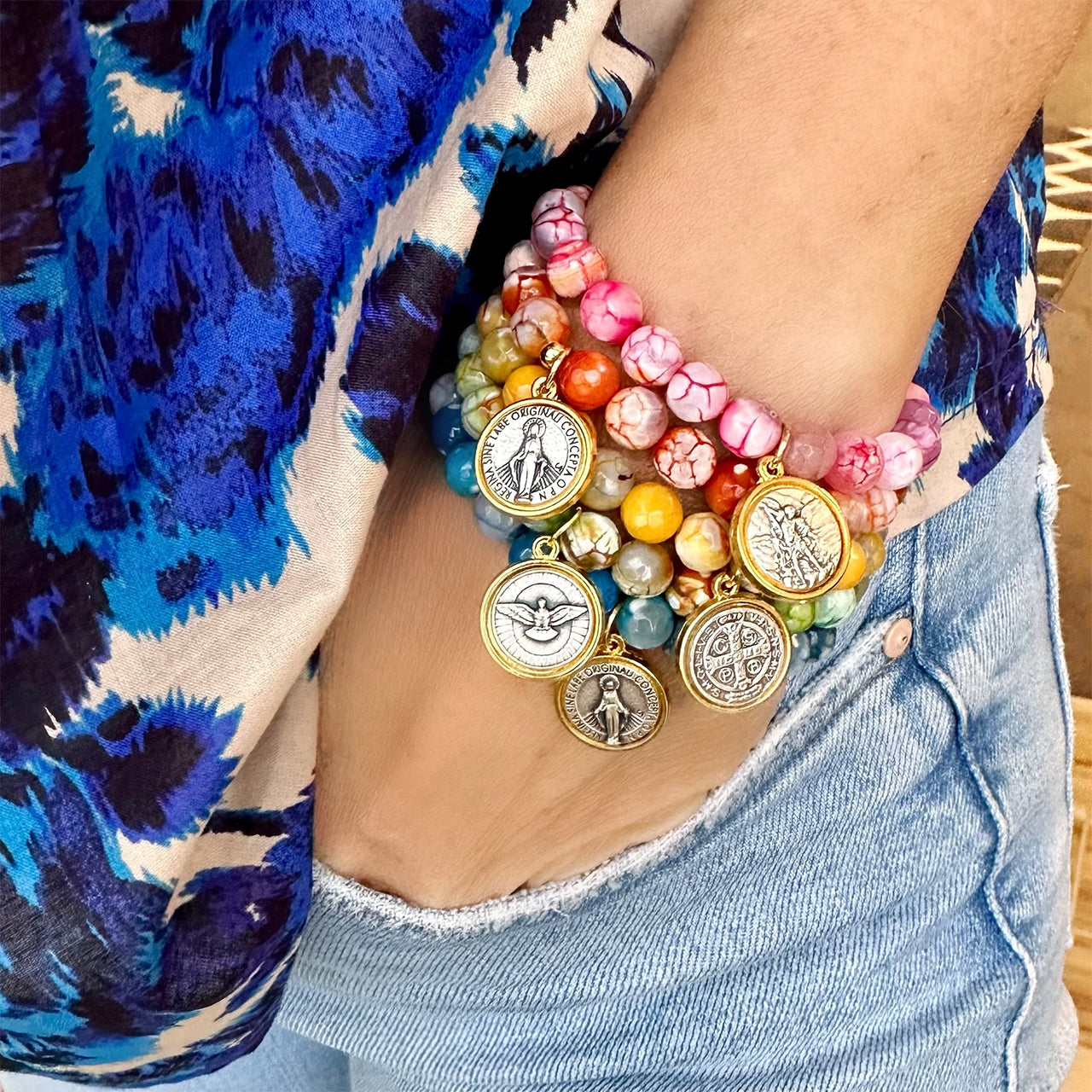 Colorful agate gemstone Catholic charm bracelets worn stacked on wrist