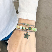 scarlett pave fire agate gemstone bracelets stacked  with flower pave charm bracelet and robin triple pave beaded bracelet