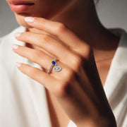 Love Lisa Serena Evil Eye Protection Stretch Ring worn on hand in silver with blue crystal accent and pavé evil eye charm