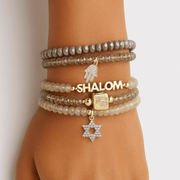 shalom on a hand model with pretty pave charms