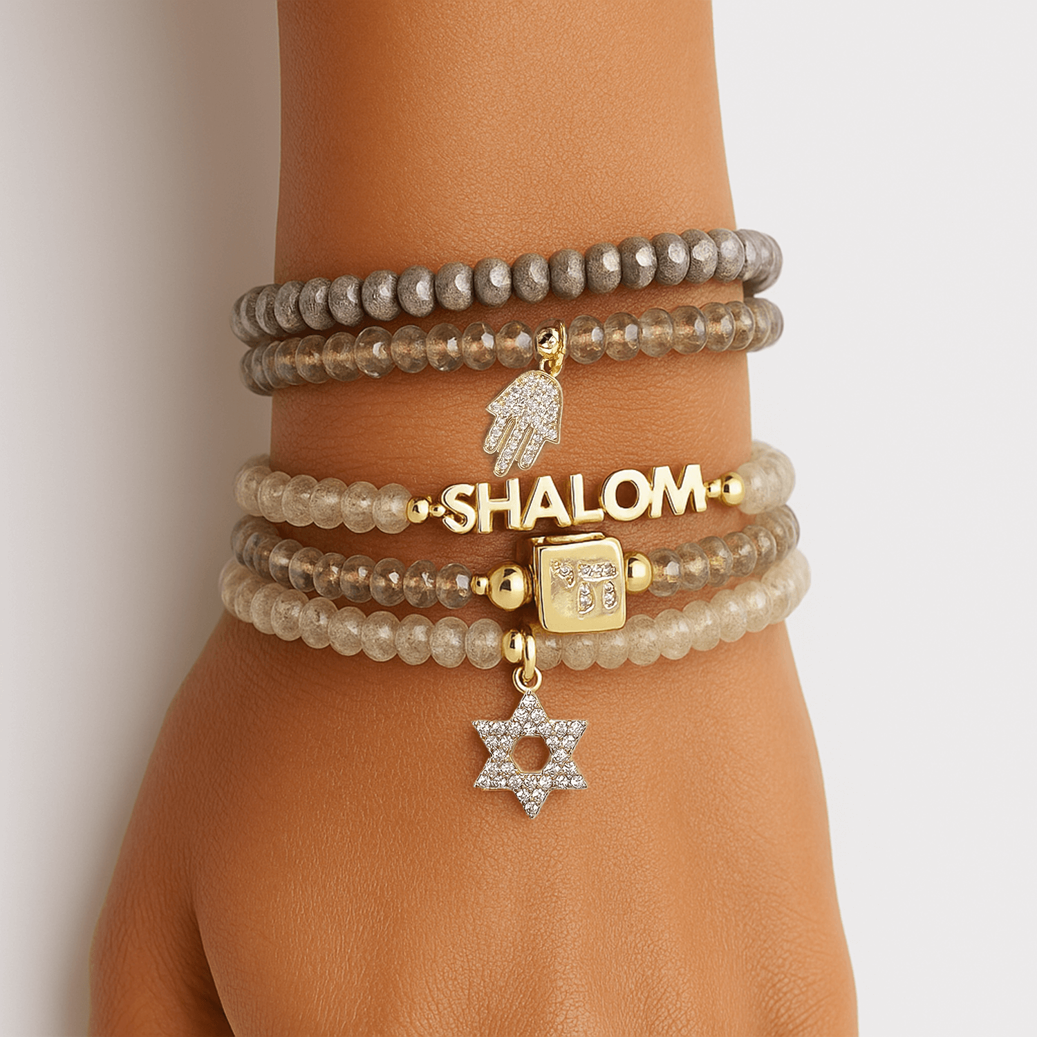 shalom on a hand model with pretty pave charms