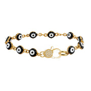 Love Lisa Shari Evil Eye Pavé Clasp Bracelet with black and white evil eye beads, gold-tone connecting links, and crystal pavé front clasp on white