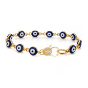 Love Lisa Shari Evil Eye Pavé Clasp Bracelet with glossy blue and white evil eye beads, gold-tone connecting links, and sparkling crystal pavé front clasp on white