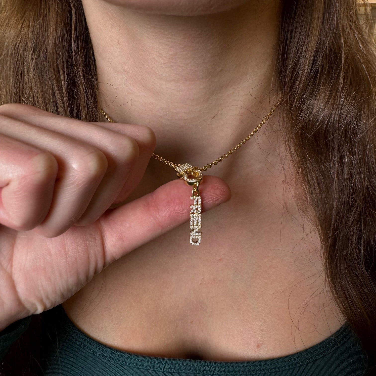 shimmering friend word charm with pave crystals in gold finish on clasp necklace detail shown being worn 