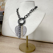Love Lisa shimmering word charms layered with pave heart charm on clasp necklace on display