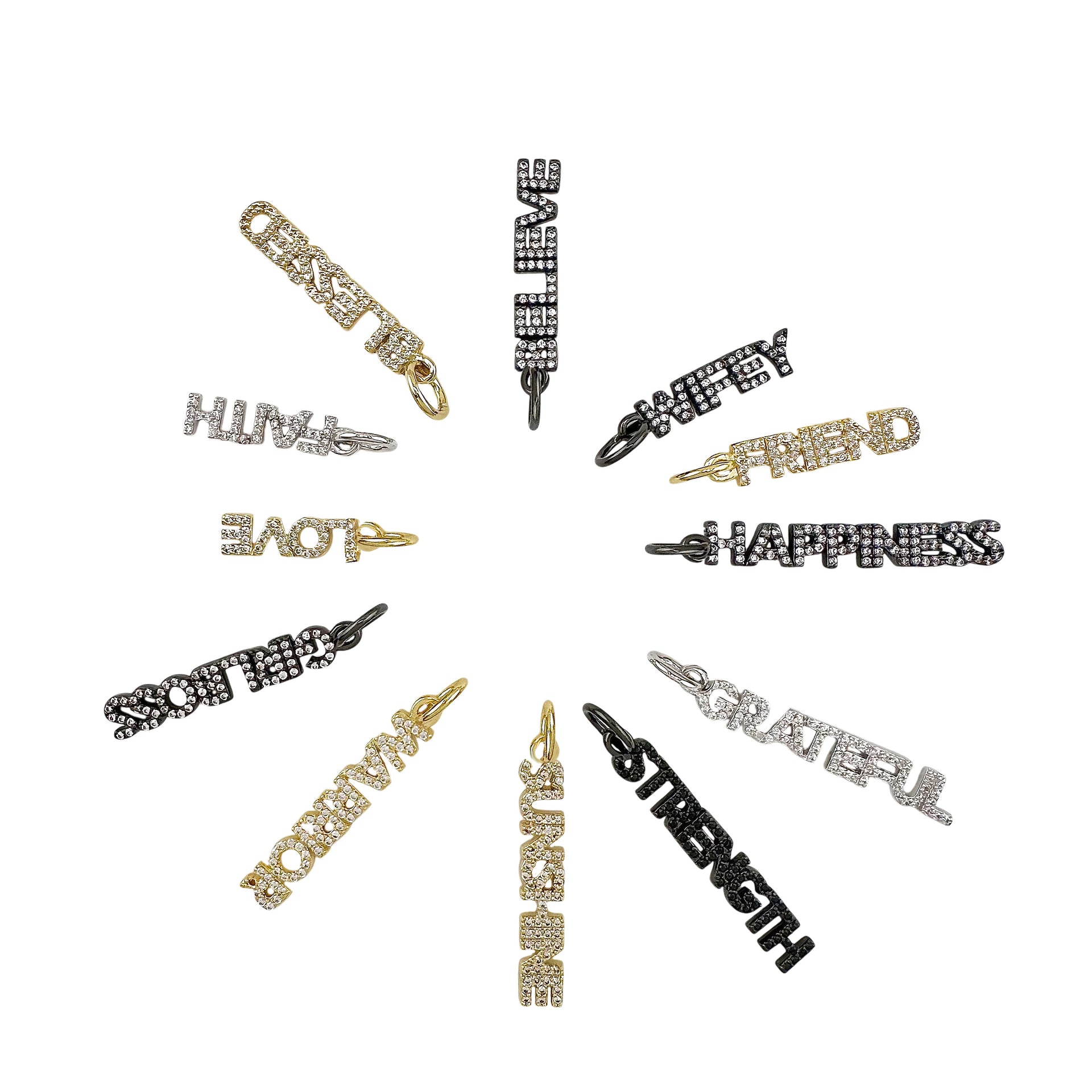 A collection of crystal-encrusted charms with various positive words written on them, such as Strength, Love, and Happiness, in gold, silver, and black colors.