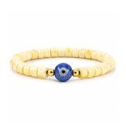 Sienna Ceramic Evil Eye Stretch Bracelet in Empire Yellow with glossy ceramic beads gold-tone accents and ceramic evil eye focal bead