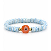 Sienna Ceramic Evil Eye Stretch Bracelet in light blue with glossy 6mm ceramic beads gold-tone accents and ceramic evil eye focal bead