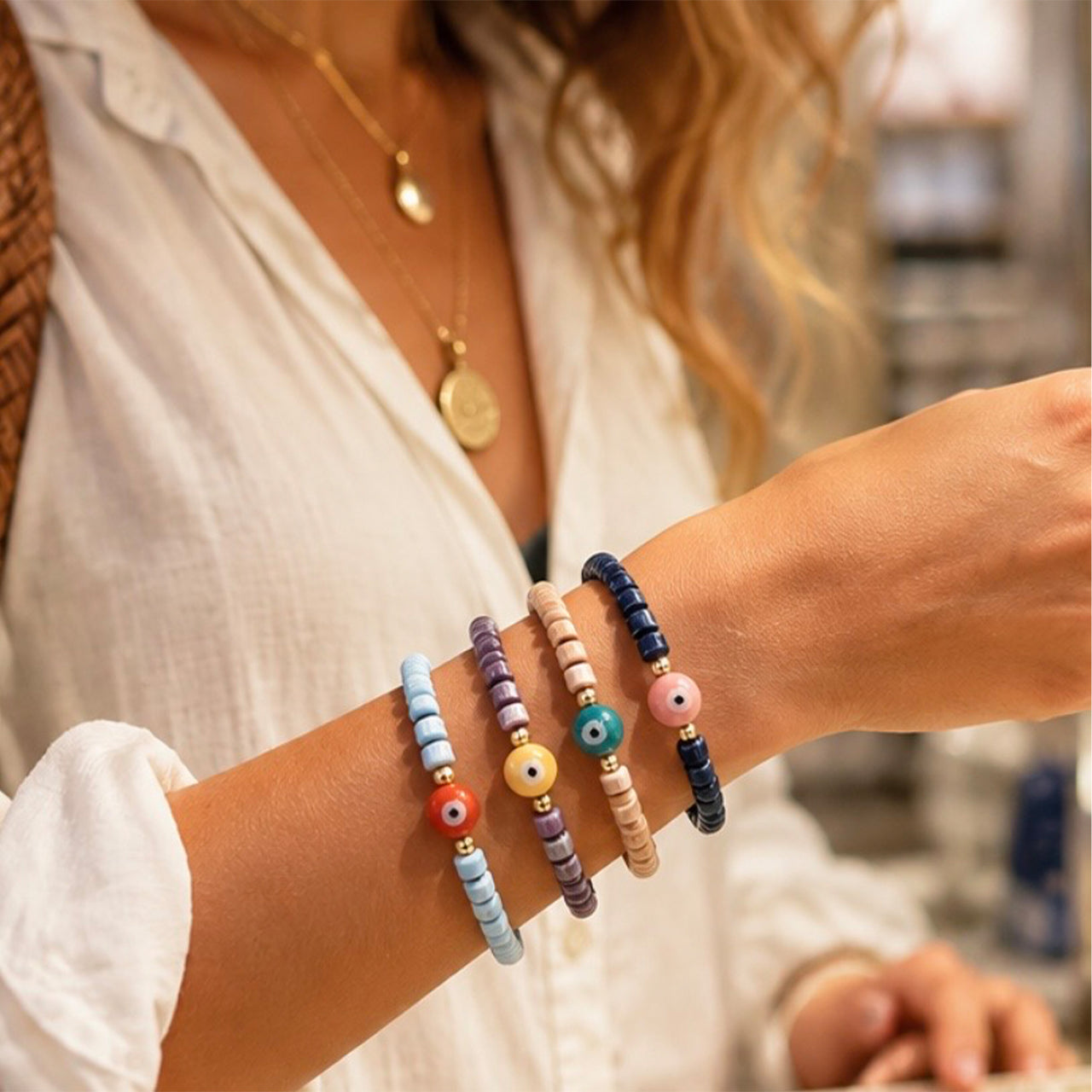 Love Lisa Sienna Ceramic Evil Eye Stretch Bracelets worn in a colorful bracelet stack with glossy ceramic beads and gold-tone accents