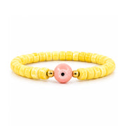 Sienna Ceramic Evil Eye Stretch Bracelet in yellow with glossy 6mm ceramic beads gold-tone accents and ceramic evil eye focal bead