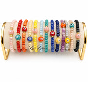 Love Lisa Sienna Ceramic Evil Eye Stretch Bracelets displayed in multiple colors with ceramic evil eye focal beads and gold-tone accents