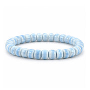 A beaded stretch bracelet made of light blue ceramic round beads, displayed on a clean white background.