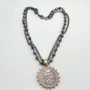 gunmetal gold skull coin necklace styled in heart shape with double chain