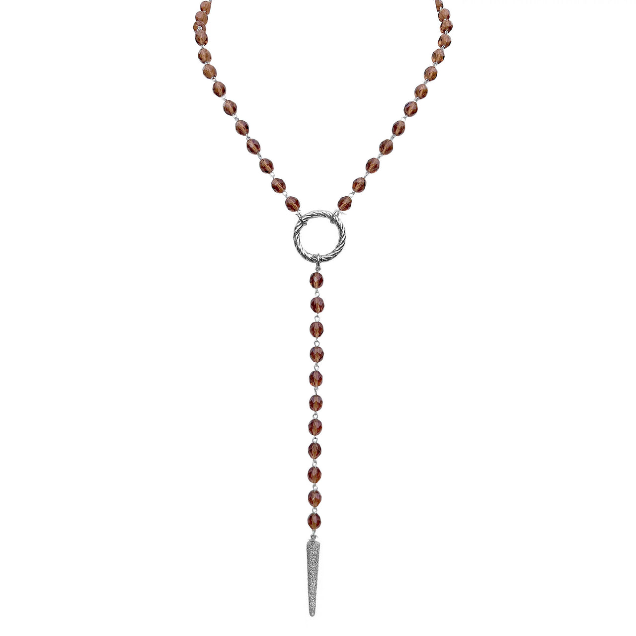 Necklace with brown beads and a silver pendant on a white background