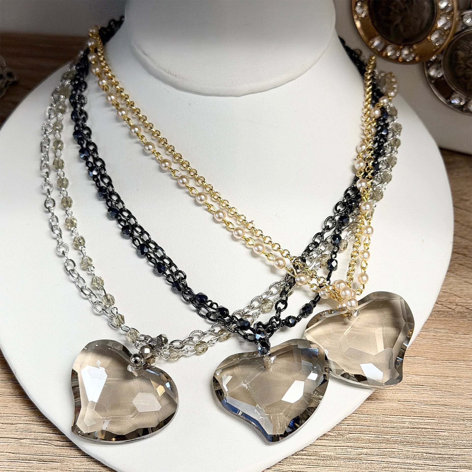 smokey glass heart double strand necklace group display gold silver and gunmetal layered chain necklaces with smokey heart pendants
