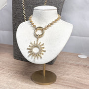 Gold sunburst charm with pavé detailing from Love, Lisa Jewelry – available in Black Diamond and Gunmetal finishes