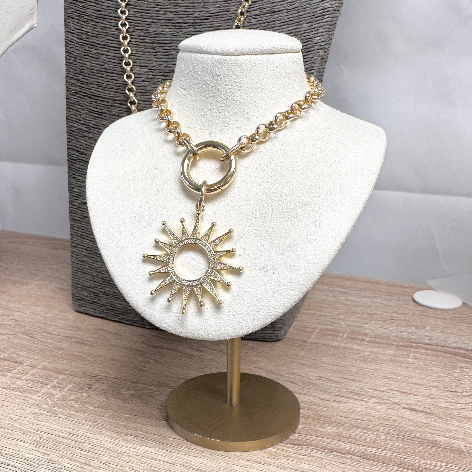 Gold sunburst charm with pavé detailing from Love, Lisa Jewelry – available in Black Diamond and Gunmetal finishes