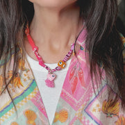 Soleil bandana charm necklace detail with evil eye beads tassel glossy heart charm enamel accents star details and scarf fabric