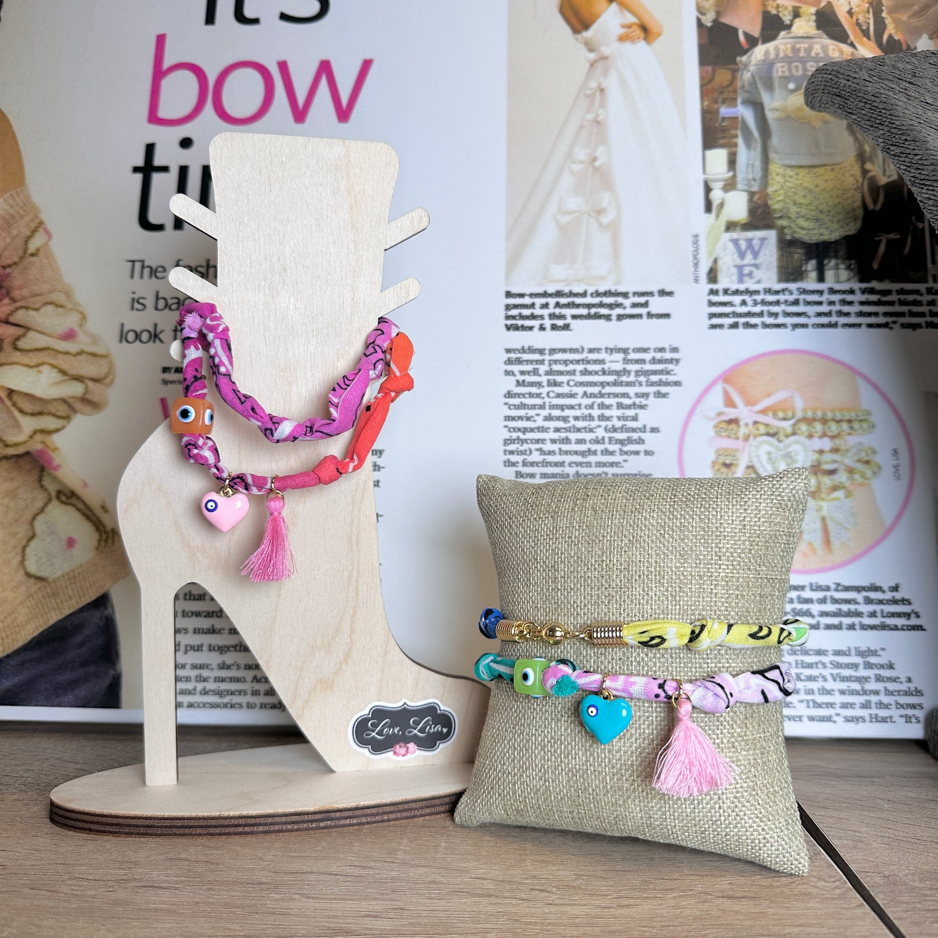 Soleil Charm Wraps styled as bracelets on display stand with packaging


