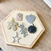 Sophia Sun Pendant displayed with moon and star charms – celestial theme