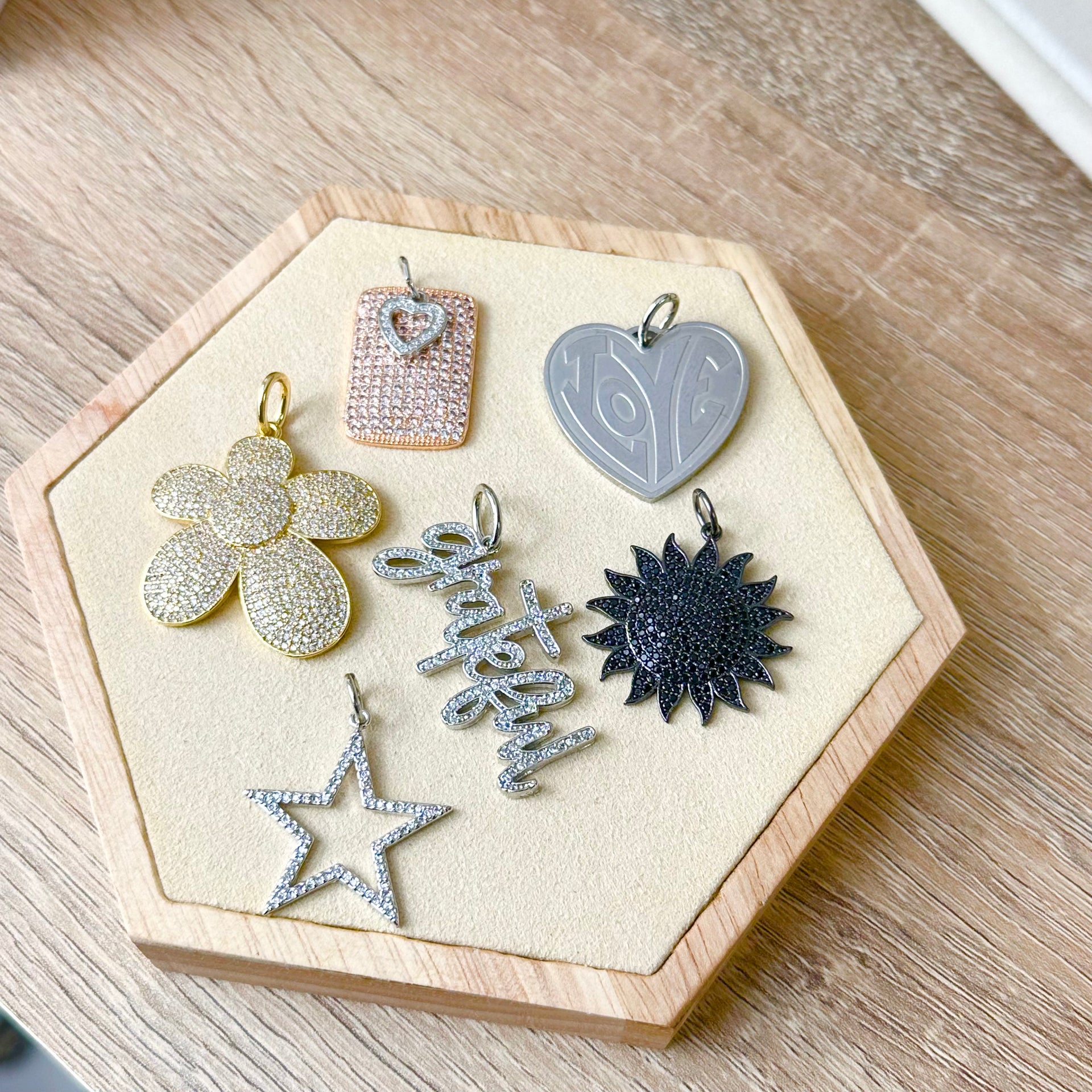 Sophia Sun Pendant displayed with moon and star charms – celestial theme