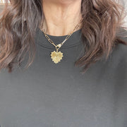 Stacy Gold Fan Heart Charm styled on Pam Paperclip Clasp Necklace worn on model with black top"