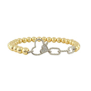 A two-tone (silver and gold) bracelet with a heart-shaped clasp, featuring a chain-like structure and beaded elements.