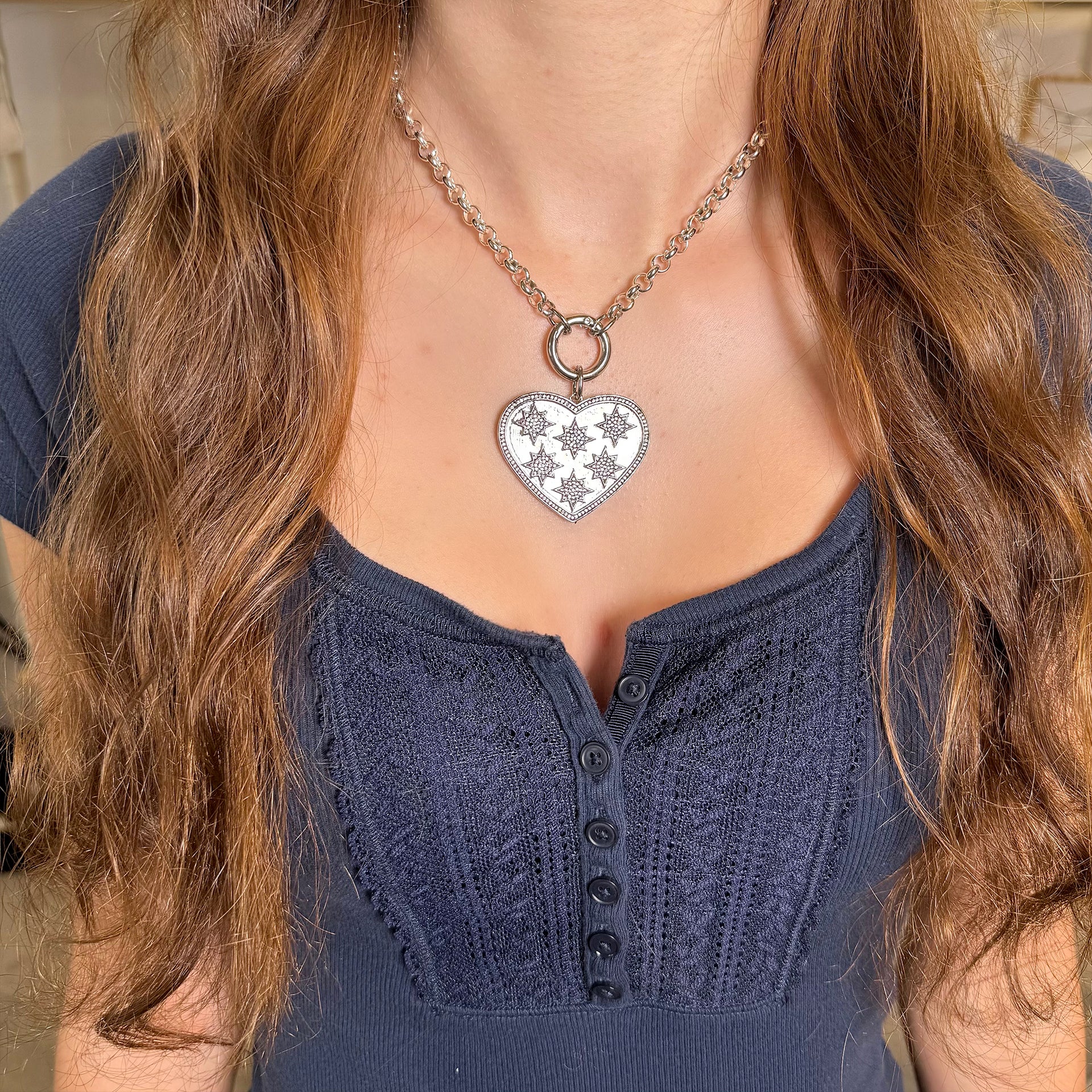 starburst heart charm worn on model layered with clasp necklace love lisa
