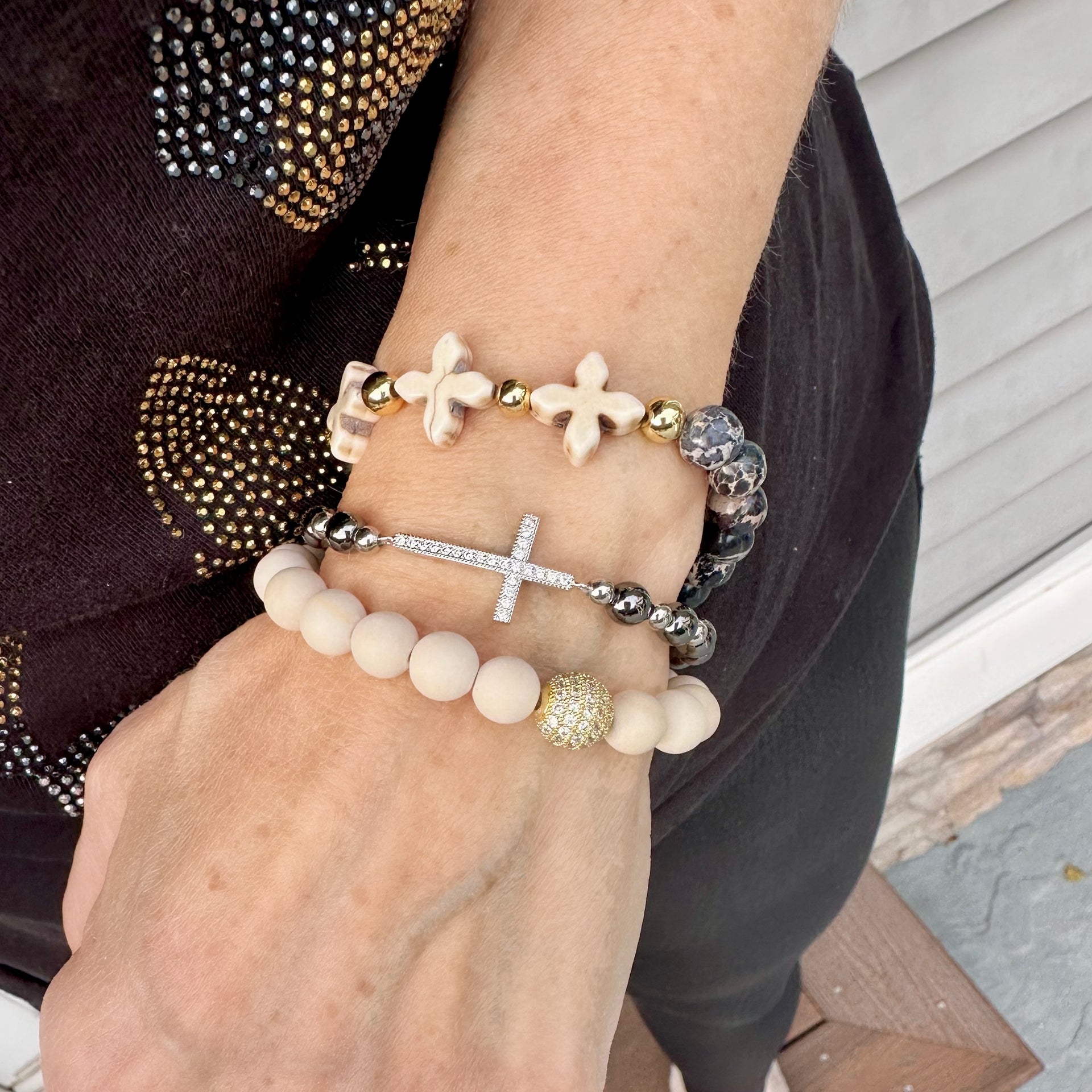 stretch diamond cross bracelet gold worn on model with stacked bracelets love lisa