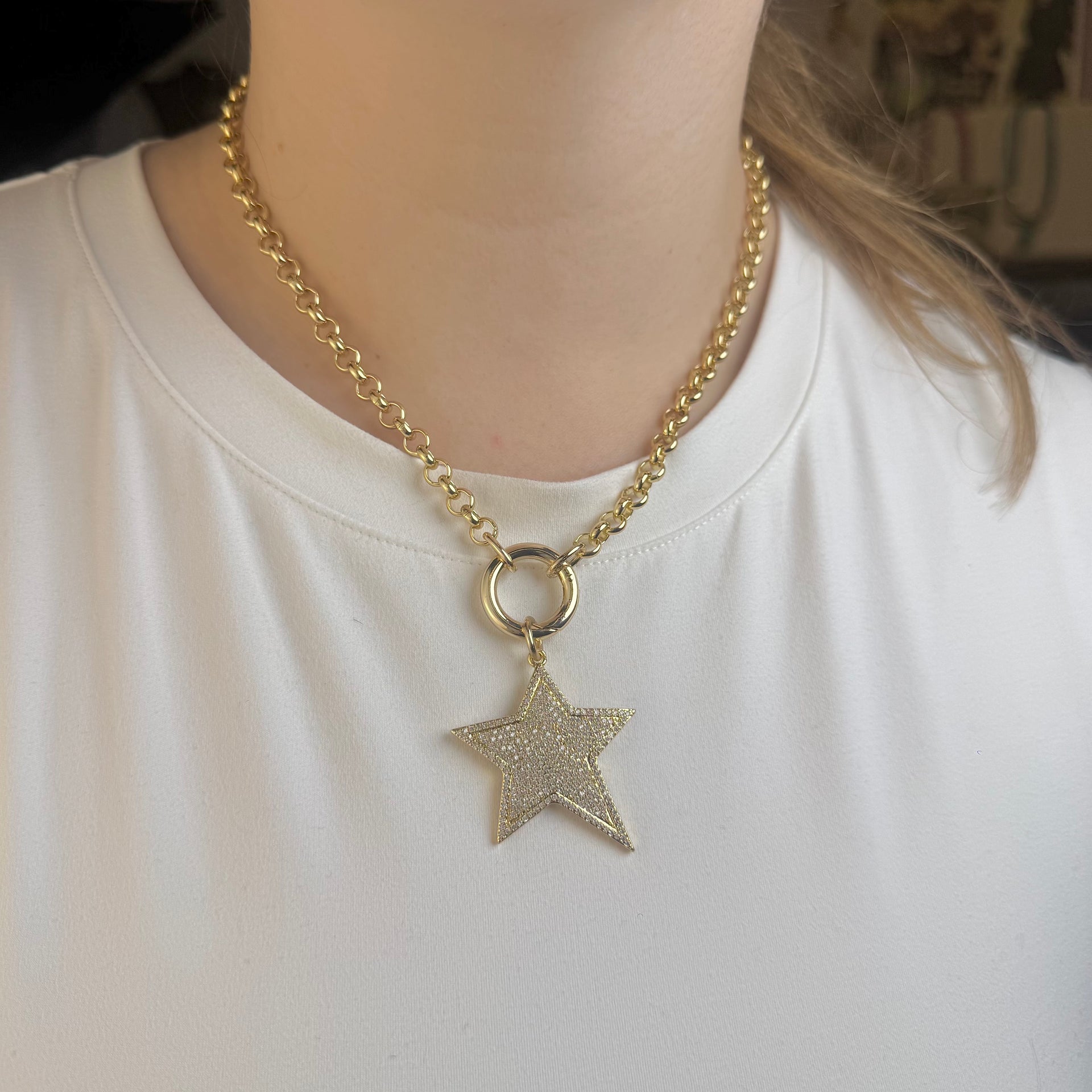 love lisa stunning star charm gold shown on gold clasp necklace on model